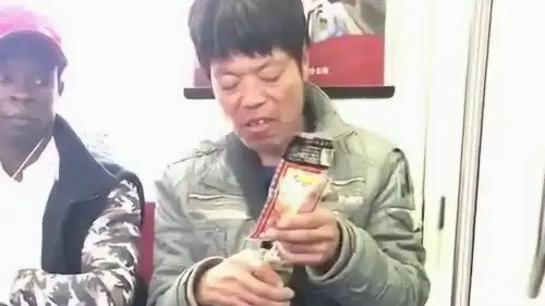 地铁偶遇一哥们喝着白酒就着鸡爪,旁边的黑人小伙表情很羡慕哦
